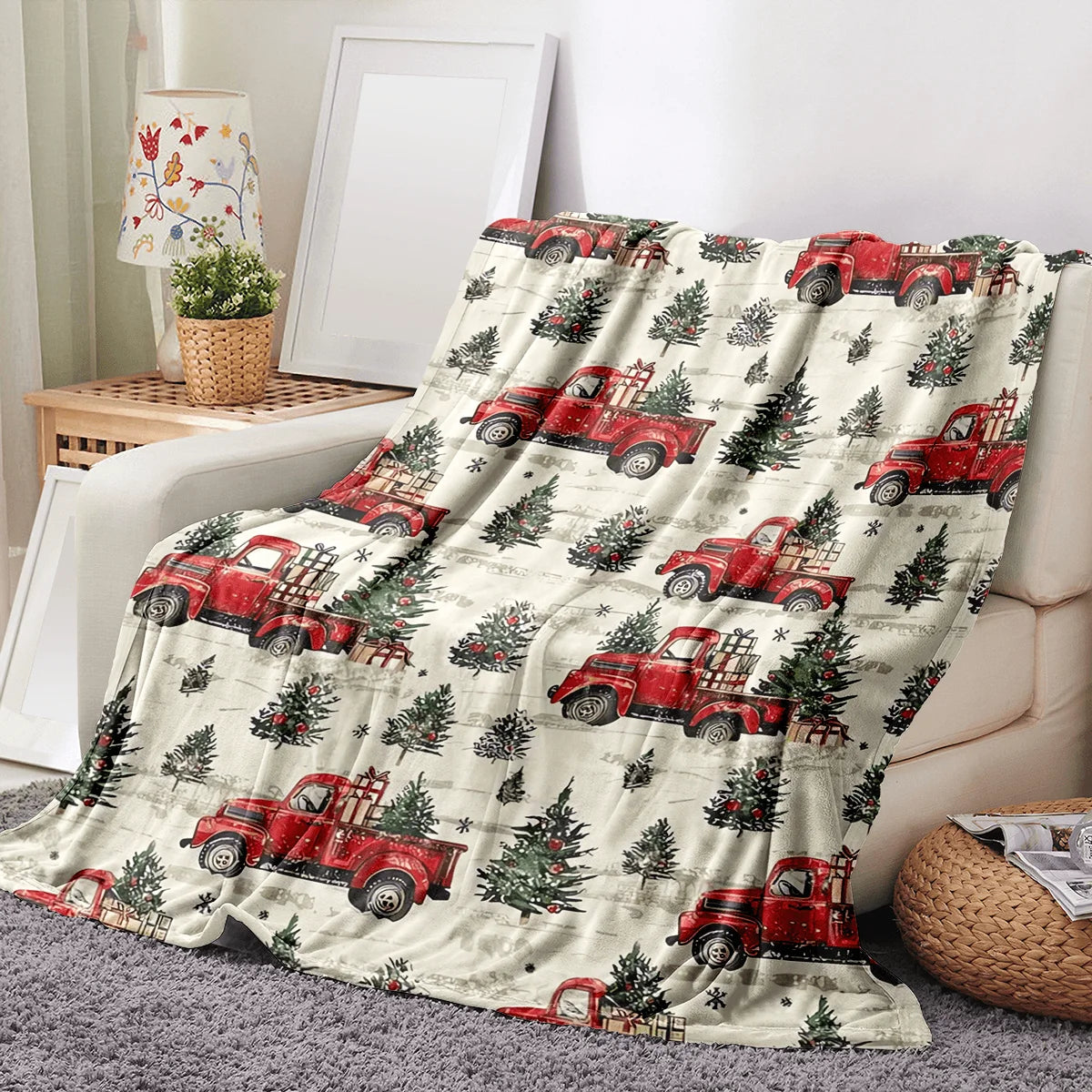 A vintage red truck Christmas throw blanket featuring numerous red pickup trucks and evergreen trees on a light background.