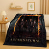 A dark themed blanket featuring characters from Supernatural with flames and the title on a black background