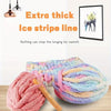 A pile of extra thick ice stripe line yarn in various pastel colors is shown next to a hanging light fixture.