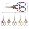 A pair of vintage stainless steel sewing scissors with purple and silver handles and blades.