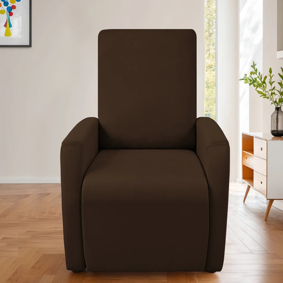 A dark brown, upholstered accent chair with a curved back and seat is shown in a bright room.
