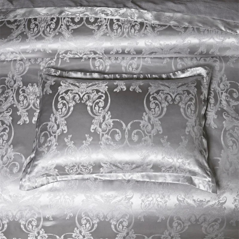 A silver luxury duvet cover set featuring intricate damask embroidery on a bed.