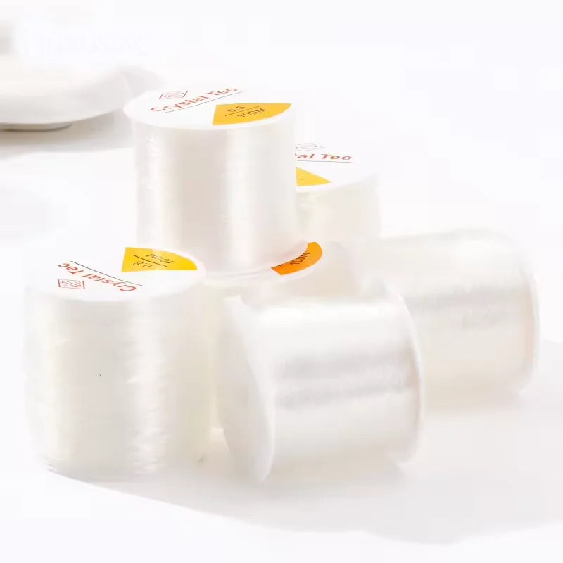 Rolls of transparent elastic cord for jewelry making labeled Crystal Tec