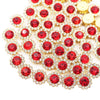 A close-up of sunflower crystal rhinestone sew-on buttons in red and gold.