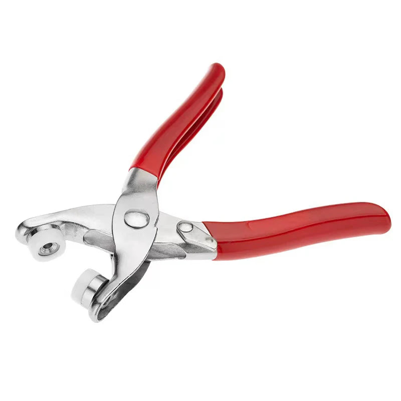 A pair of colorful metal sewing buttons with red handles and silver clasps.
