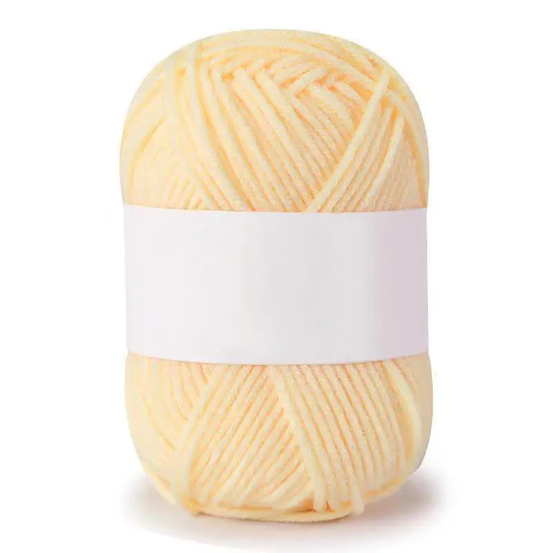 A ball of soft yellow milk cotton knitting yarn