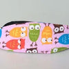 Pink fabric pillow with embroidered owls used as a baby head and neck support for strollers and car seats