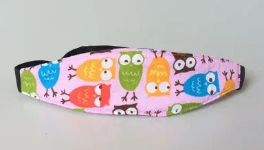 Pink fabric pillow with embroidered owls used as a baby head and neck support for strollers and car seats