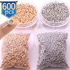 Clear plastic containers show various quantities of stainless steel eye screw pins for jewelry making in rose gold and silver