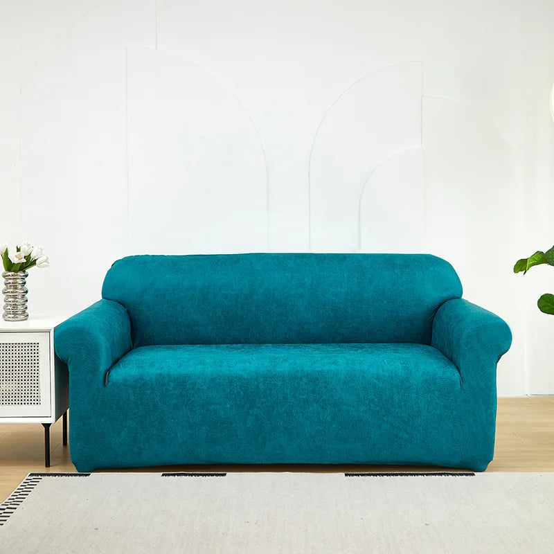A teal blue PU leather sofa slipcover in a modern living room setting.