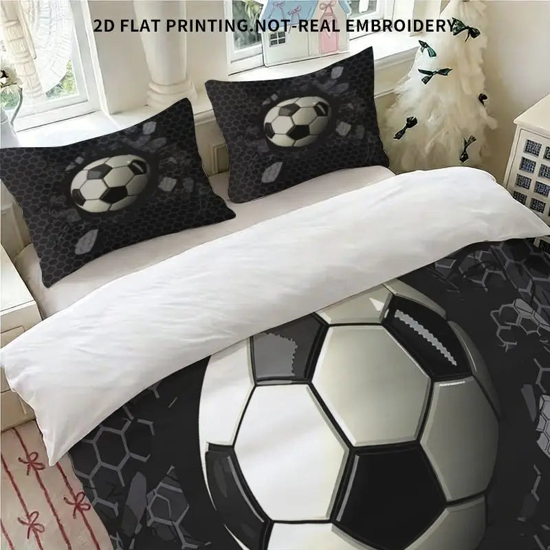 A set of three soccer ball themed duvet cover and pillowcases featuring black and white designs.