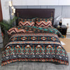 A patterned duvet cover set featuring geometric bohemian designs in shades of teal, orange, and black on a bed.
