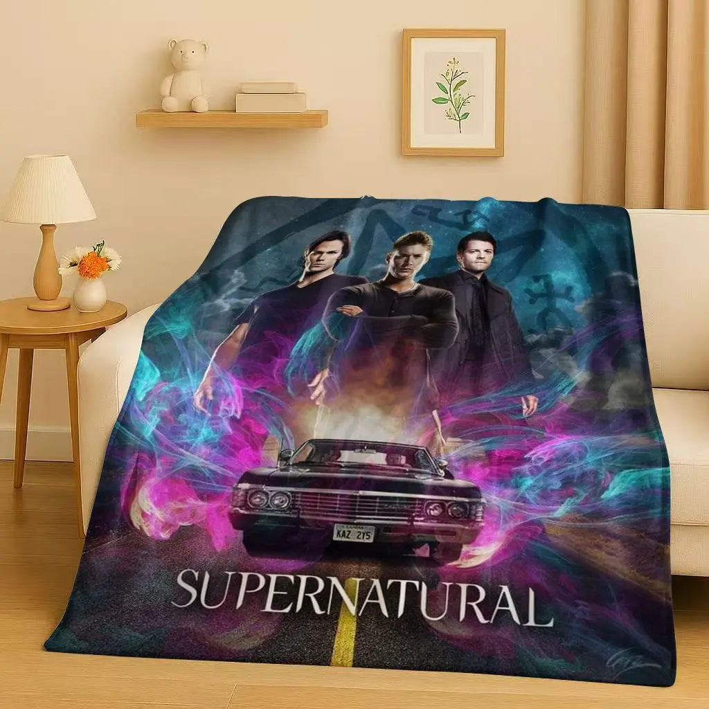 A dark blue and purple graphic blanket featuring characters from Supernatural and a vintage car.