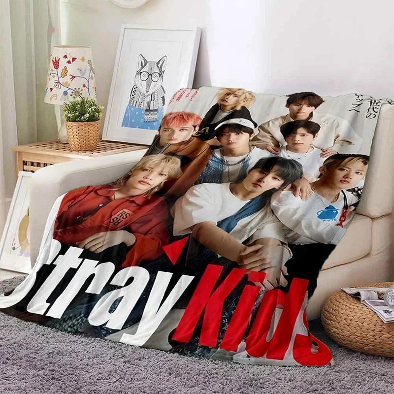 A fleece throw blanket featuring a 3D printed design of the Stray Kids Kpop group members.