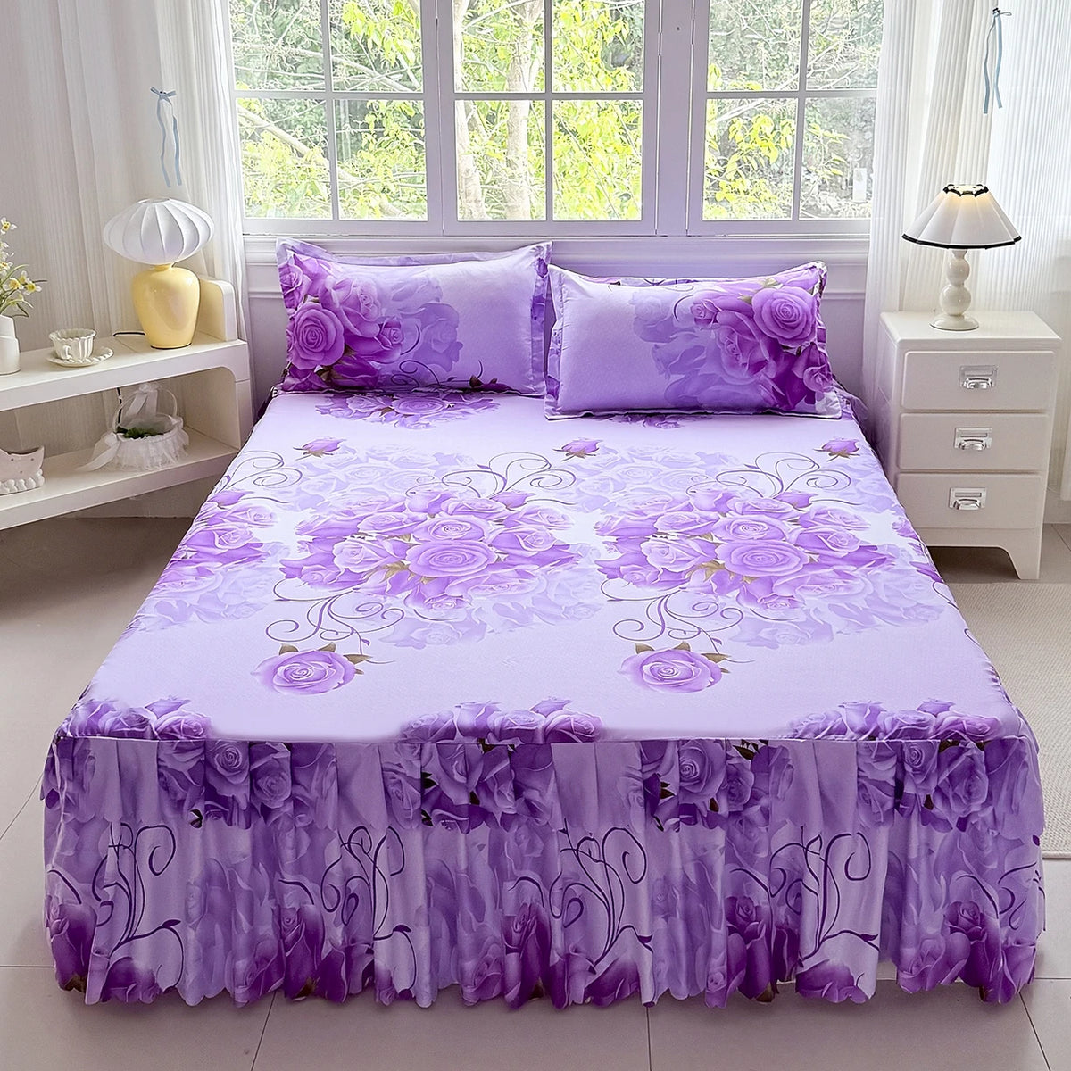 Purple floral print bed skirt set with matching pillows and duvet cover displayed on a bed.