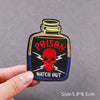 Black embroidered patch featuring a red skull and the text POISON WATCH OUT on a blue background