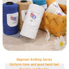 A collection of blue, yellow, and white yarn spools and a woven basket showing various thicknesses for knitting projects.