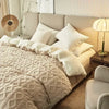 A cozy fleece blanket in beige and white diamond pattern draped over a light-colored sofa.