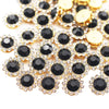 Gold and black sunflower crystal rhinestone sew-on buttons scattered on a white background
