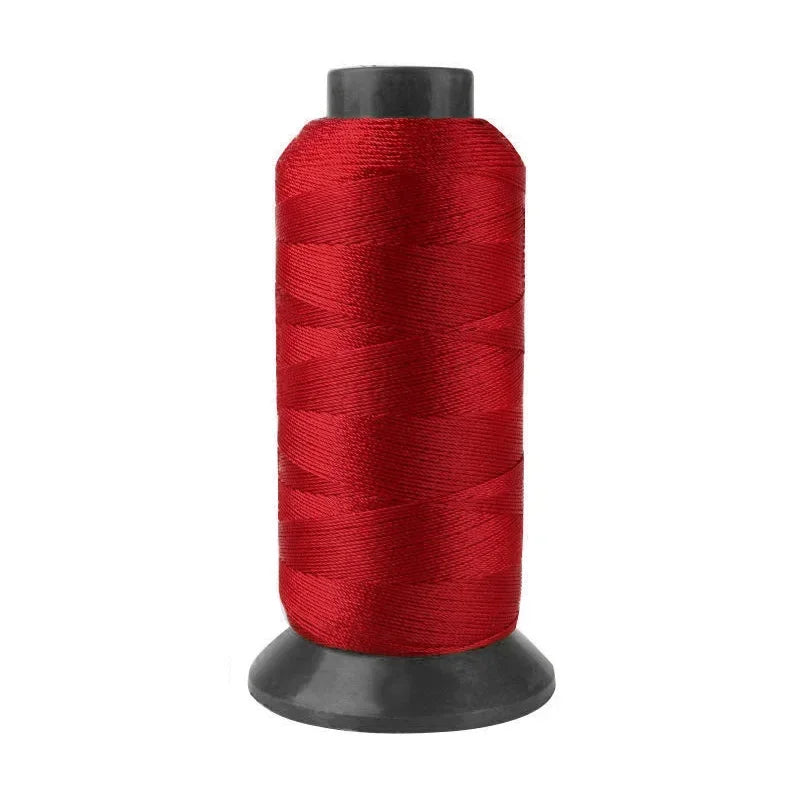 A roll of heavy duty 3-ply nylon sewing thread in a deep red color.