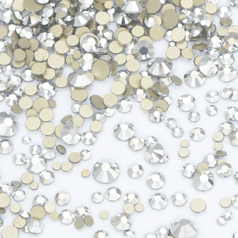 A pile of clear and gold glass rhinestones for DIY crafts