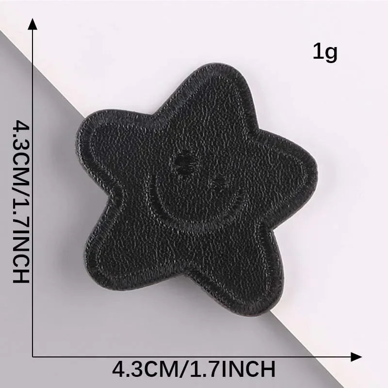 A black embroidered leather patch with a star shape is shown against a white background.