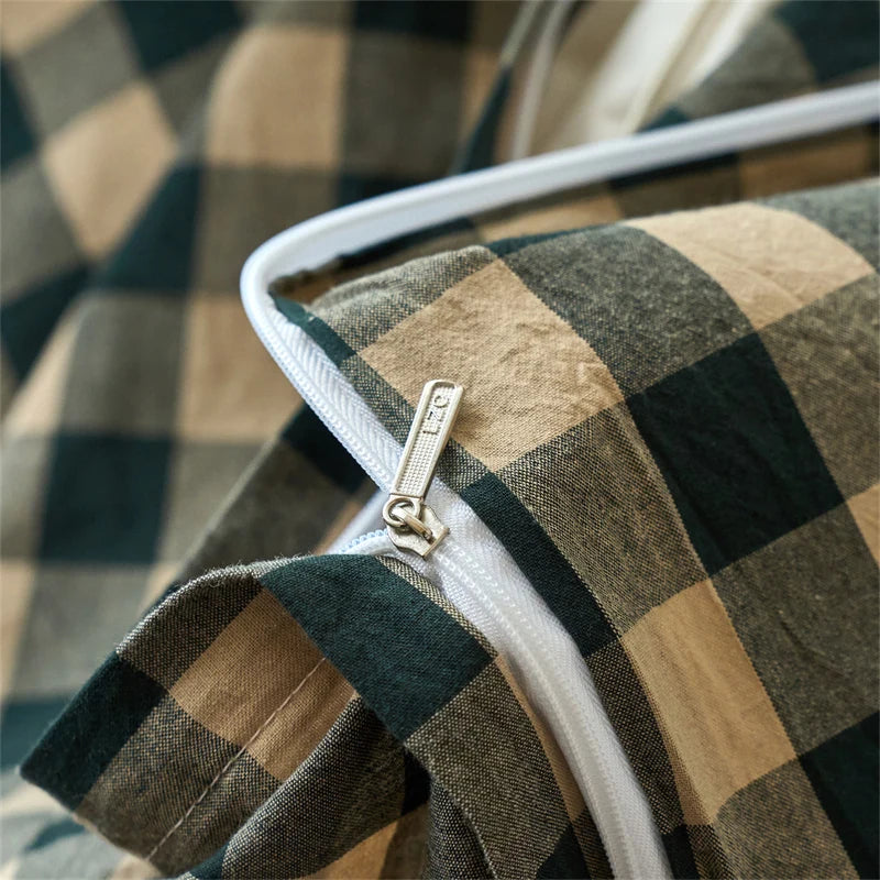 Close-up of a hand-dyed cotton plaid duvet cover set in earthy tones.