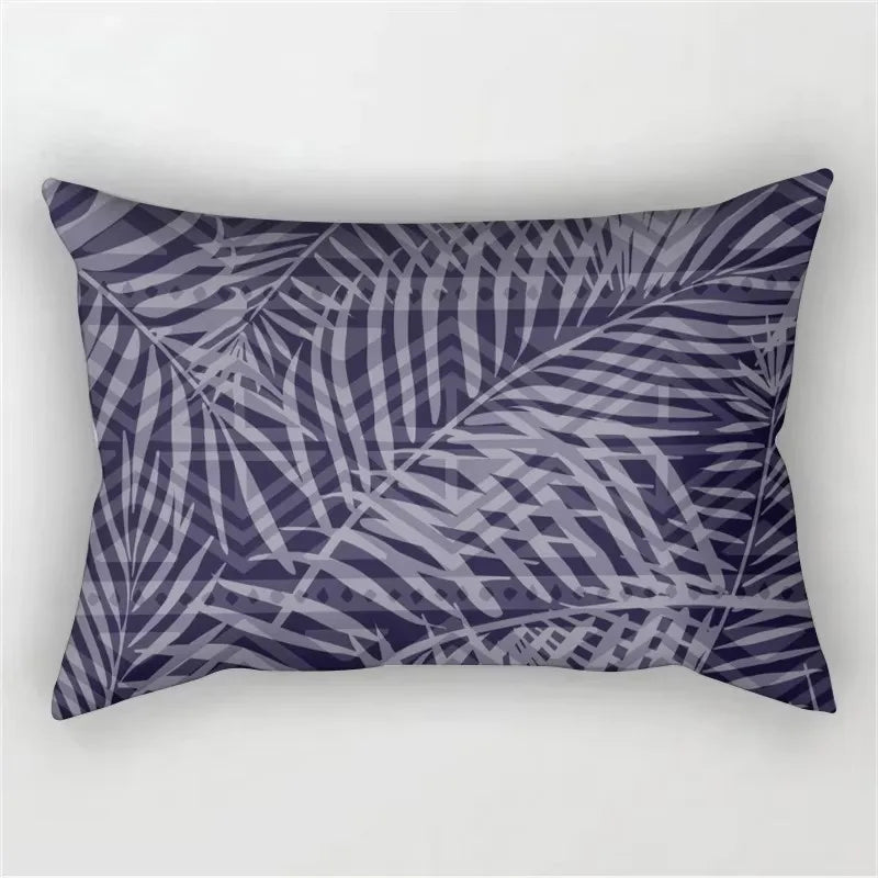 A rectangular pillowcase featuring a dark purple and gray tropical leaf print.