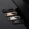 A set of four metal and plastic zipper pullers displayed against a dark background.