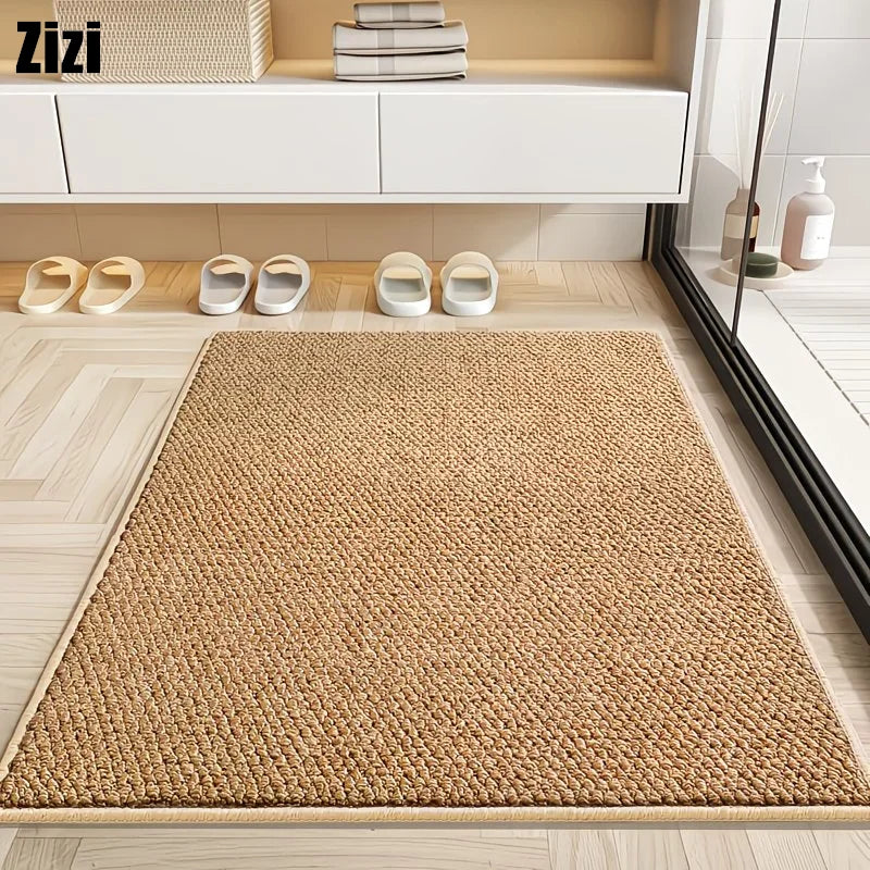 A natural sisal jute rug laid on a light wooden floor in front of white storage cabinets.