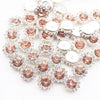 Silver and rose gold crystal rhinestone sew-on buttons arranged in a floral pattern