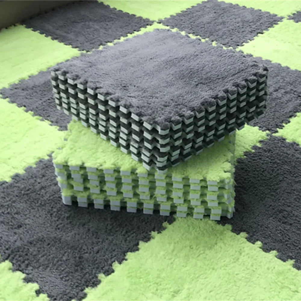 A stack of gray soft plush EVA foam play mat tiles resting on a lime green checkered floor.