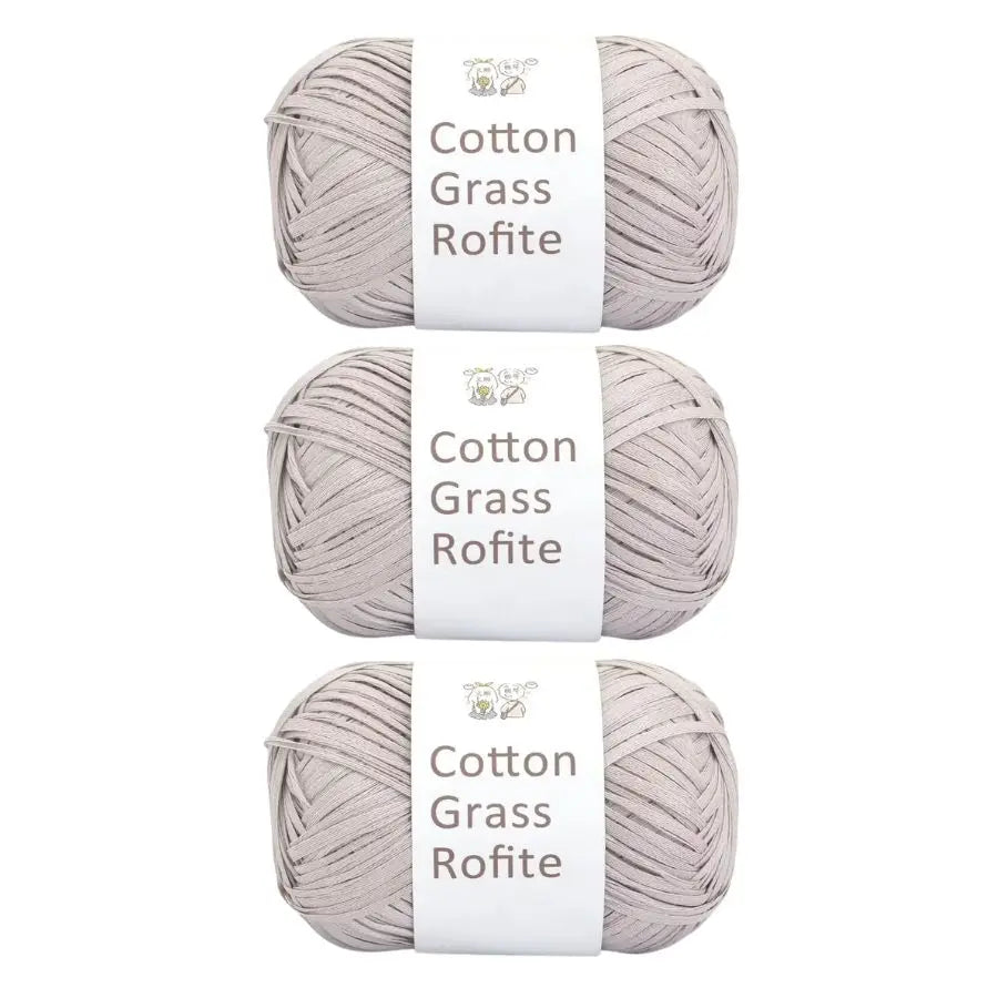 A set of natural cotton grass roving yarn in a light beige color, packaged on white labels.
