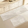 A rectangular gray waterproof non-slip kitchen floor mat with subtle wavy lines is displayed on a light-colored cabinet.