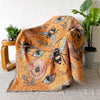 A bohemian geometric throw blanket featuring an orange background with stylized bees and eyes.