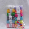 A clear plastic bag contains various colors of milk cotton yarn skeins for a crochet kit.