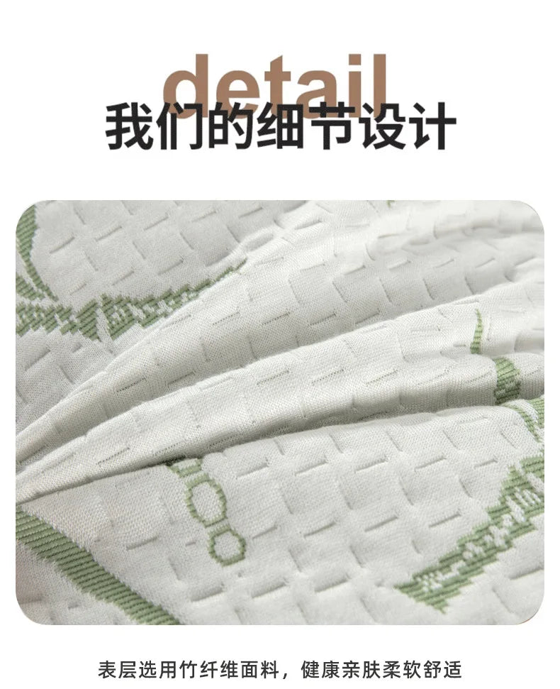 Close-up of a white quilted fabric with green embroidery, showing the detail of a bamboo pillow protector.