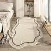 A cream colored irregular plush area rug with subtle gray edging placed on a light wood floor.