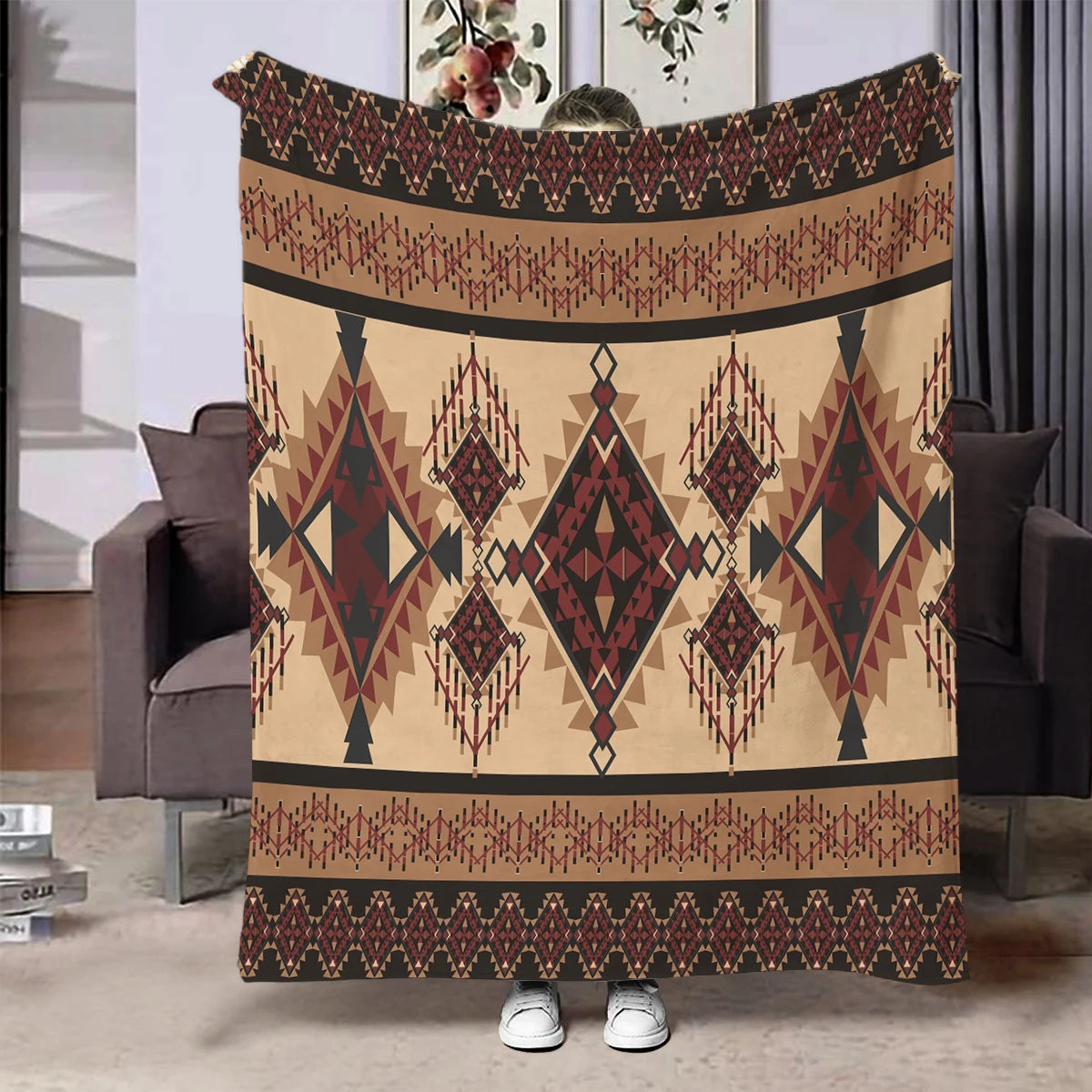 A beige flannel throw blanket featuring an ethnic print with geometric patterns in brown and maroon tones.