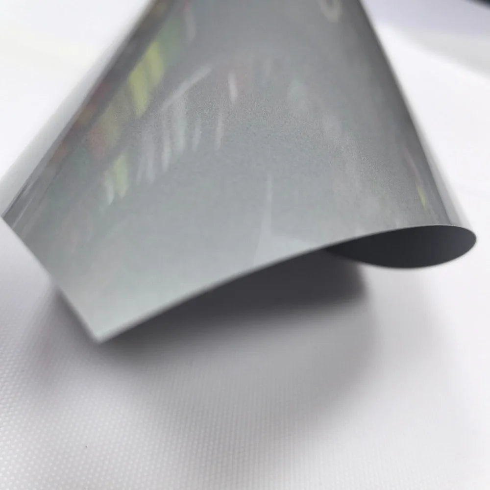 A sheet of gray heat transfer vinyl for apparel, shown at an angle against a white background.