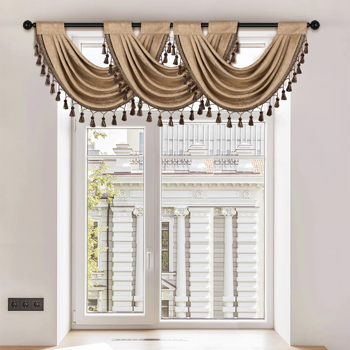A beige European style window curtain valance with tassels draped over a white door frame.