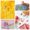 A collection of colorful plastic stitch markers in various shapes and colors for knitting and crochet projects.
