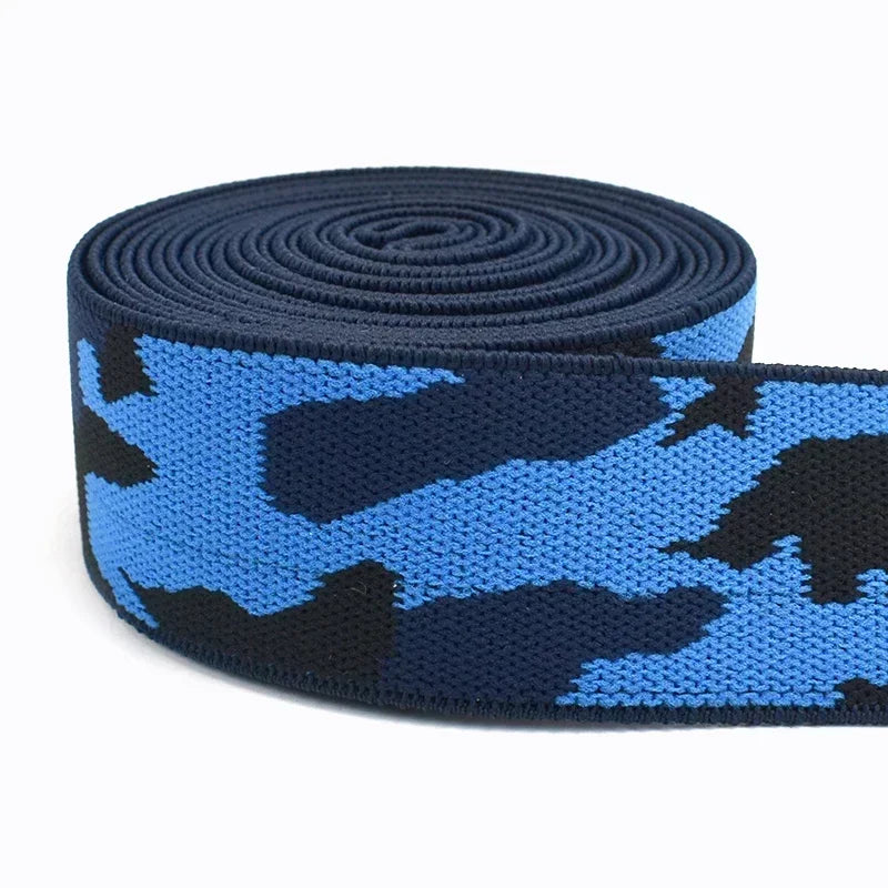 Dark blue and black camouflage elastic stretch ribbon rolled up for sewing and craft projects