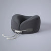 A gray U-shaped memory foam travel neck pillow with a cooling cover and adjustable strap.