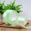 Roll of light green satin ribbon for gift wrapping and DIY crafts