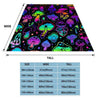 A colorful mushroom pattern flannel throw blanket displayed in a triangular shape.