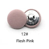 A round, flesh pink fabric-covered shank button with a silver backing is shown.