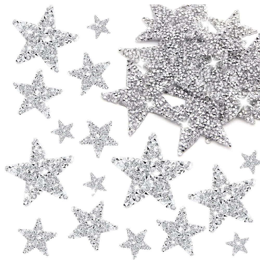 A collection of silver glitter star iron-on patches for clothing repair and decoration.