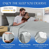 A couple relaxing in a bed with a gray sheet, showing features like deep pockets, quality stitching, and a strong elastic str