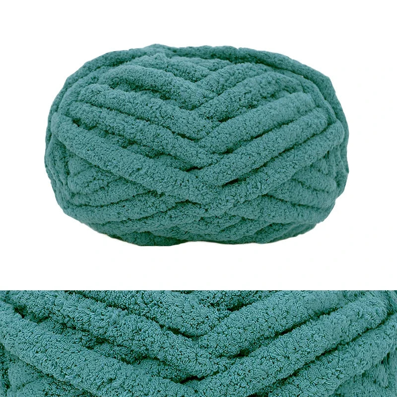A close-up of a teal hand-knitted wool finger line scarf with a textured, ribbed pattern.